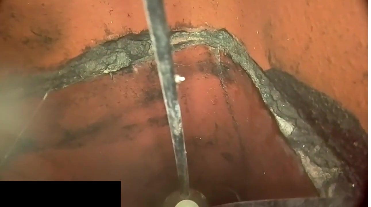 Chimney camera inspection footage showing a cracked mortar joint in a flue liner